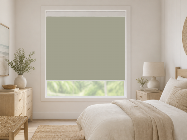 Linen blackout roller shade in a light coastal guest bedroom