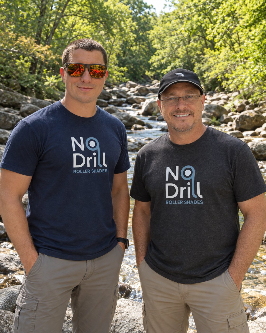 Two partners of No Drill Roller Shades in branded shirts, standing together by a creek