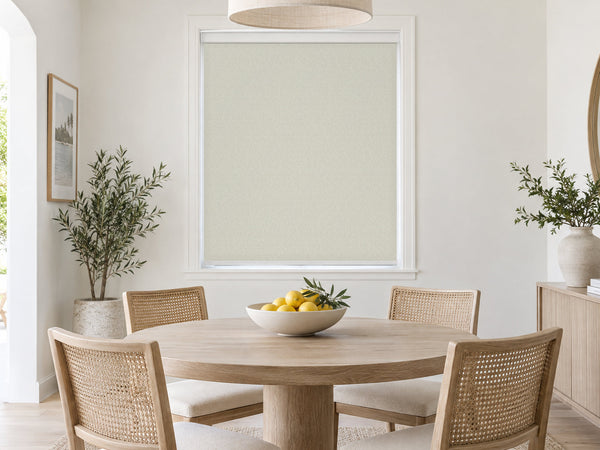 Taupe light-filtering roller shade in a bright dining room